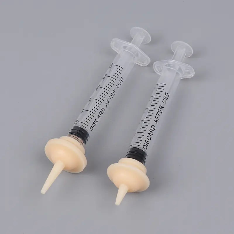two transparent plastic pet feeding syringes with black rubber seals and beige silicone nipple tips marked discard after use in 3ml and 5ml sizes for controlled feeding.