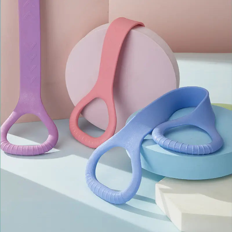 pastel-colored silicone grab handles in lavender coral and light blue with textured grip rings designed for yoga stretching belt to enhance back and arm fitness effect using tension rope