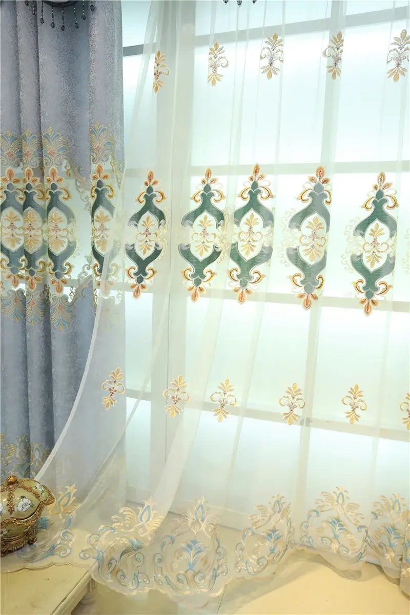 Elegant white sheer living room curtain with intricate green and gold embroidered patterns designed for french window use