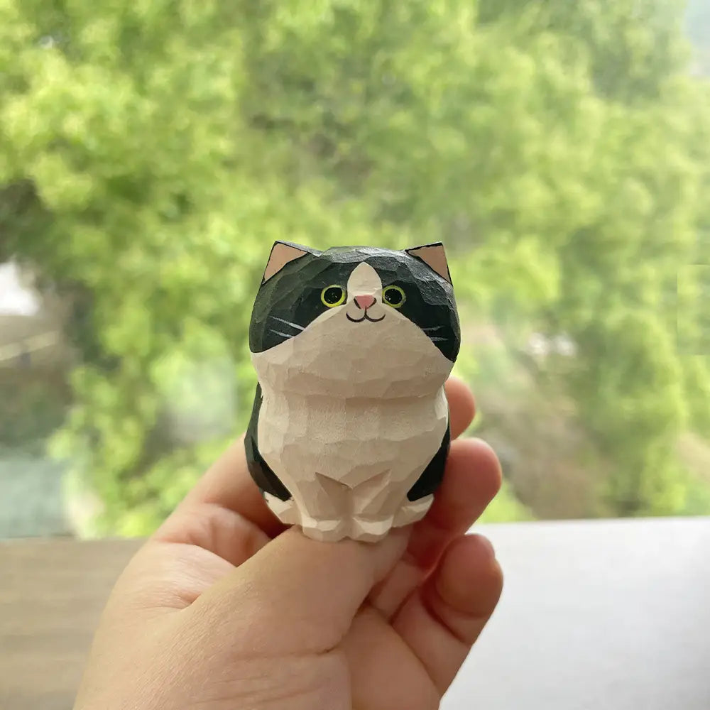 Handcrafted wooden cat figurine desk decor featuring a charming black and white carved design with green eyes and a pink nose available as an actual product factory direct.