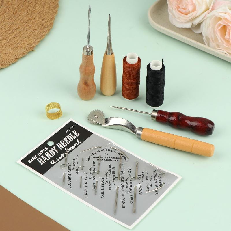 Leather sewing tool kit for diy craft and repair featuring a basic home handy needle assortment package with assorted sewing needles wooden-handled tools and spools of thread.