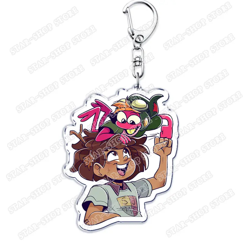 Clear acrylic amphibia anime keychain featuring a cartoon character with brown hair holding a pink phone and two colorful creatures on the head.