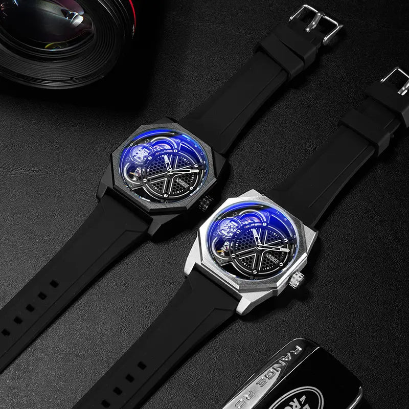 Two automatic skeleton mechanical watches for men with octagonal faces feature glowing blue dials and black rubber straps, one with a matte black casing and the other in silver, resting on a dark surface.