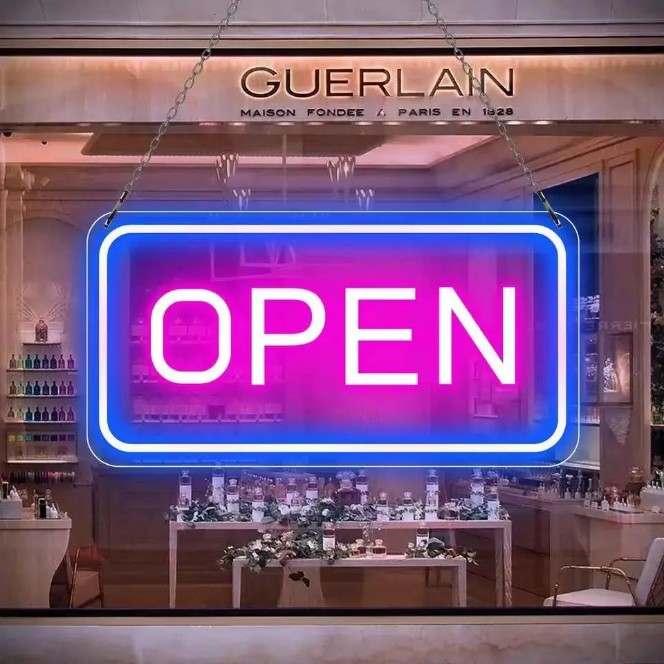 led open neon sign with adjustable brightness featuring vibrant neon lights in a glowing pink and blue gradient and framed in sleek white lettering as a distinctive light source.