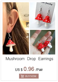 red mushroom-shaped drop earrings with white caps and stems complementing a gold angel number 7 necklace for a unique accessory set.