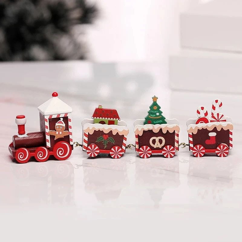 Décoration de table de vacances en train de Noël en bois, en rouge et blanc, présentant des wagons décoratifs avec des motifs de maison en pain d’épices, d’arbre et de canne de bonbon.