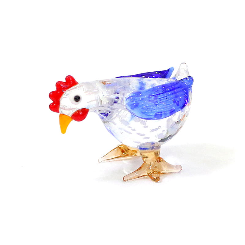 A translucent glass rooster miniature figurine with a red comb and beak blue wing accents and amber-colored feet designed as an Easter ornament.