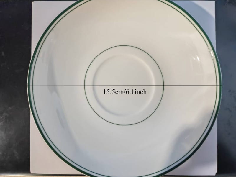 White ceramic coffee cup and saucer set with a vintage green rim and matching inner circle measuring 15.5cm or 6.1 inch in diameter.