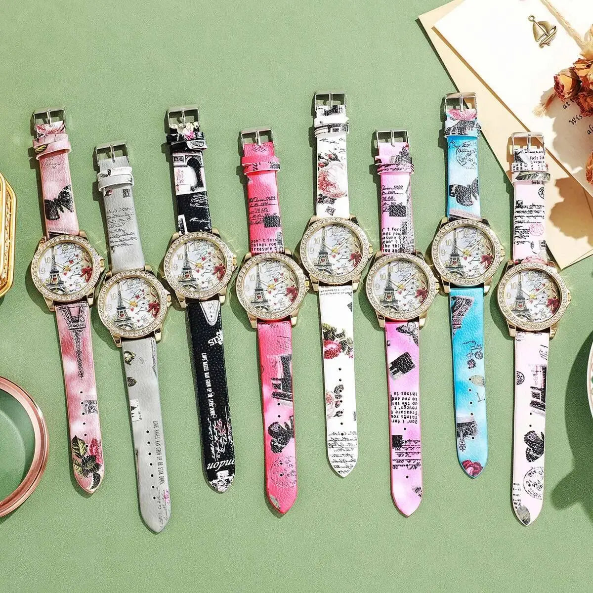 a collection of colorful paris-themed women’s quartz wristwatches with faux leather straps featuring eiffel tower and vintage script designs