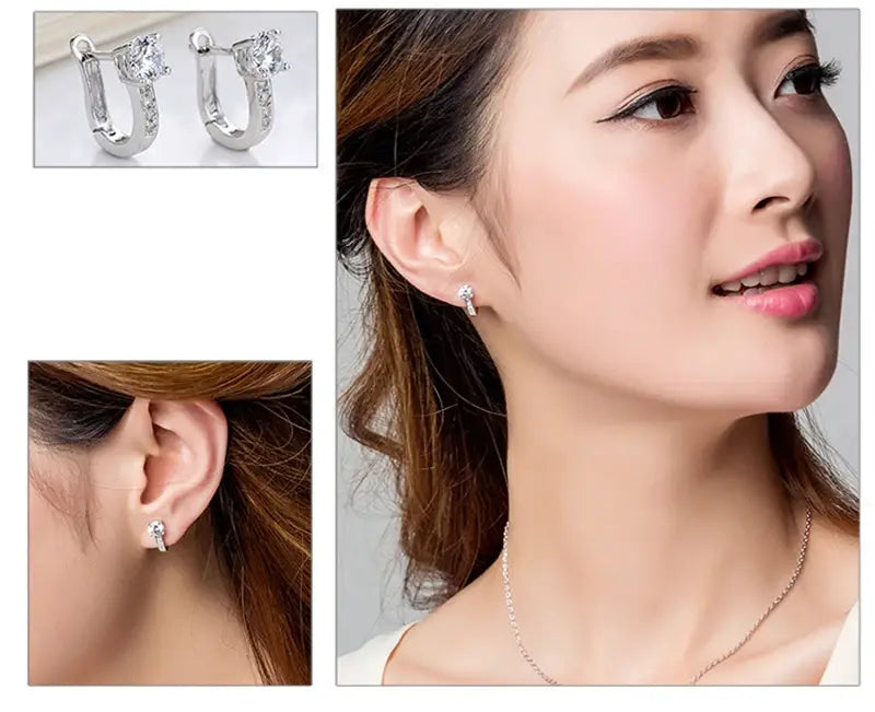 Pendientes de flores de circonio en plata de ley con diseño de aro tipo huggie plateado, adornado con cristales claros brillantes.