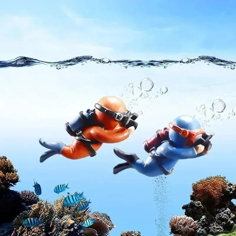 Two cartoonish scuba diver ornaments in orange and blue designed as popular aquarium decorations for fish tanks and aquatic pets.
