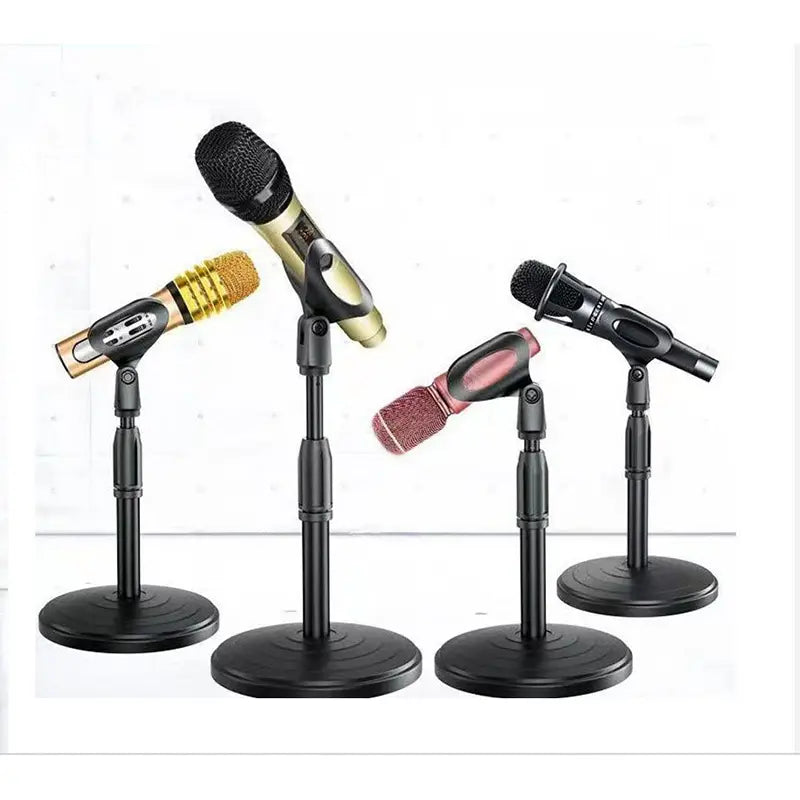 Set of four black adjustable desktop microphone stands and holders each supporting a different colored and designed handheld microphone.