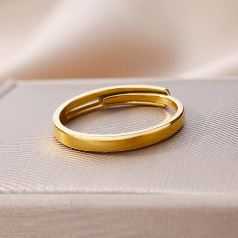 A sleek gold color stainless steel adjustable ring for women with a smooth polished finish and modern vintage wedding design.