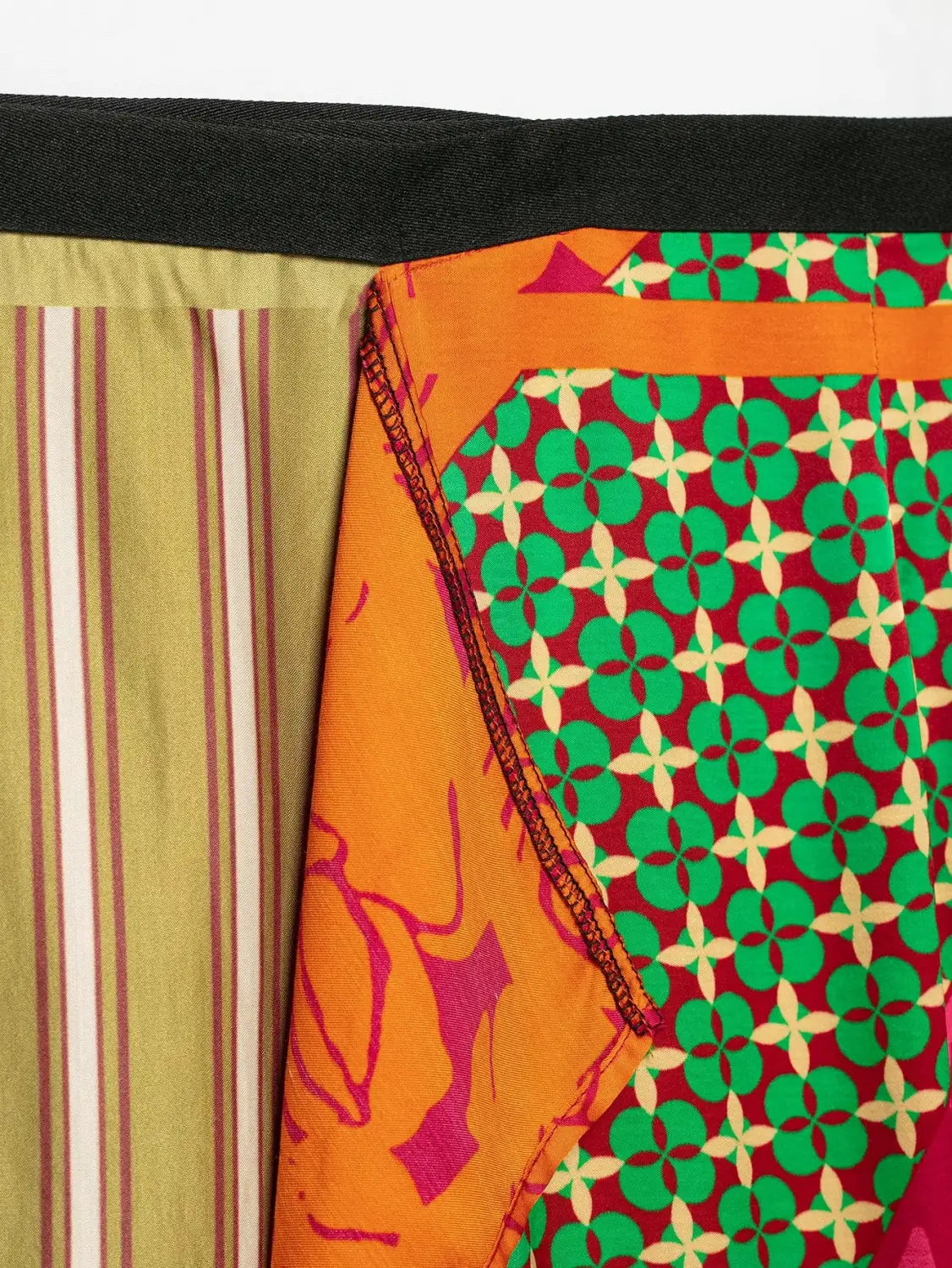 floral print two piece midi skirt set made of vibrant patchwork fabric featuring bold orange green and red geometric and abstract patterns