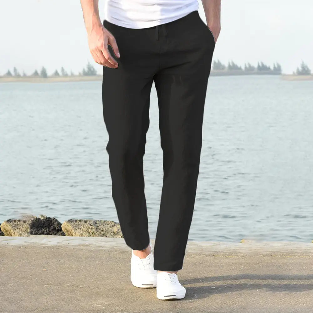 Black slim-fit men cotton linen trousers with a breathable fabric and subtle creasing for casual wear.