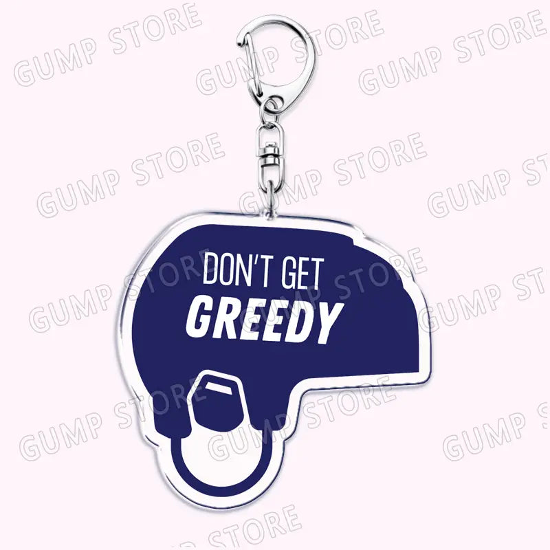 A navy blue and white acrylic keychain shaped like a speech bubble with the text dont get greedy in bold white letters and a hand holding money illustration from the Tate Mcrae acrylic keychain music fan gift collection.