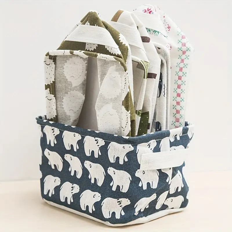 Panier de rangement pliable en tissu bleu marine avec des motifs d’ours polaires blancs et une poignée assortie, idéal pour un usage en boîte de rangement.
