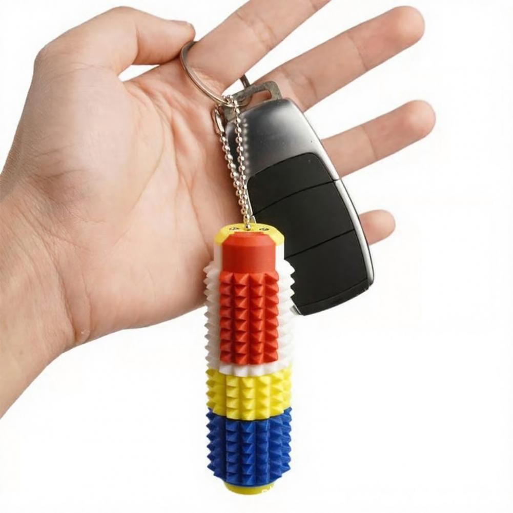 Un colorido rodillo giratorio para fidget con pinchos antiestrés 5 en 1, con secciones segmentadas con pinchos en rojo, amarillo y azul, diseñado para un alivio eficaz del estrés y estimulación sensorial