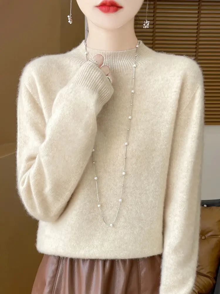 Cream-colored merino wool pullover sweater for women featuring a soft textured knit, round neckline, and long sleeves.