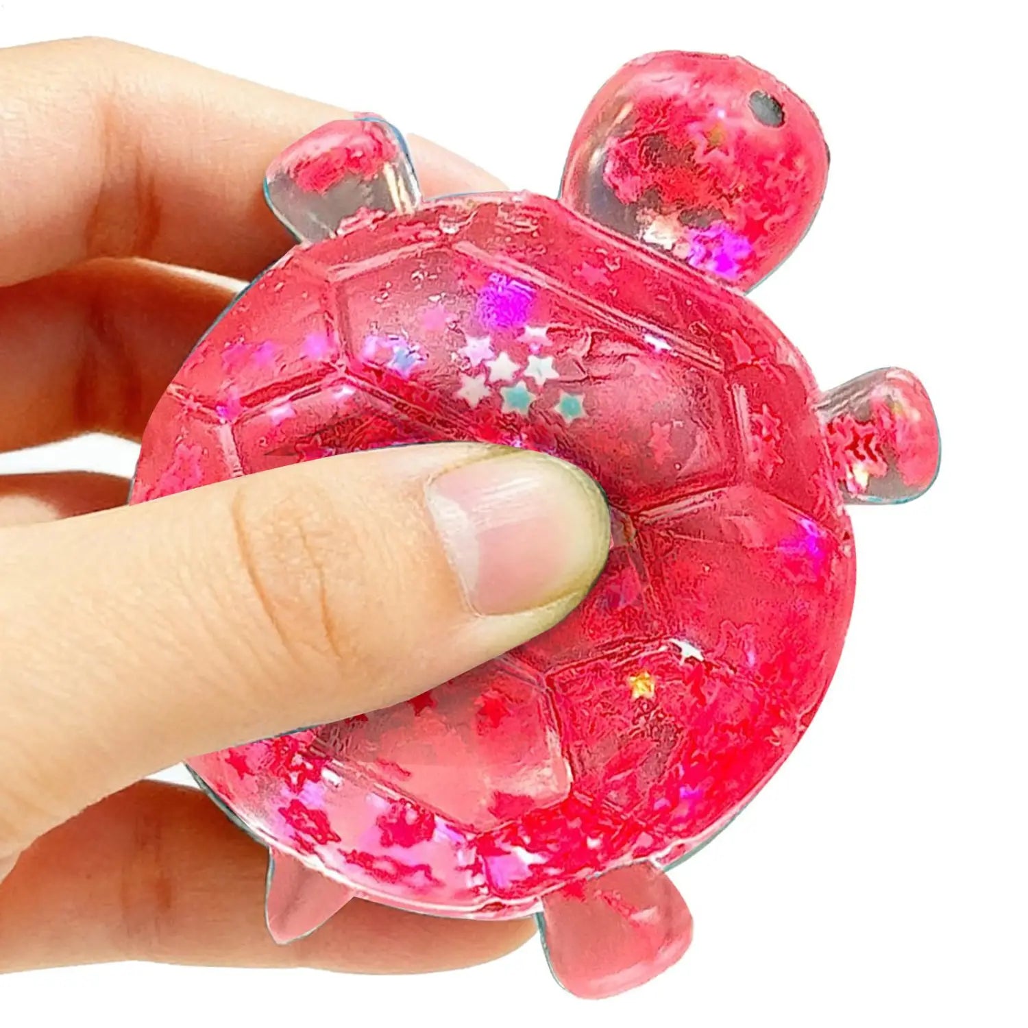 a vibrant pink translucent turtle shape squeeze toy made of squishy material with embedded glitter stars and a glossy finish designed as a sensory fidget squeeze toy