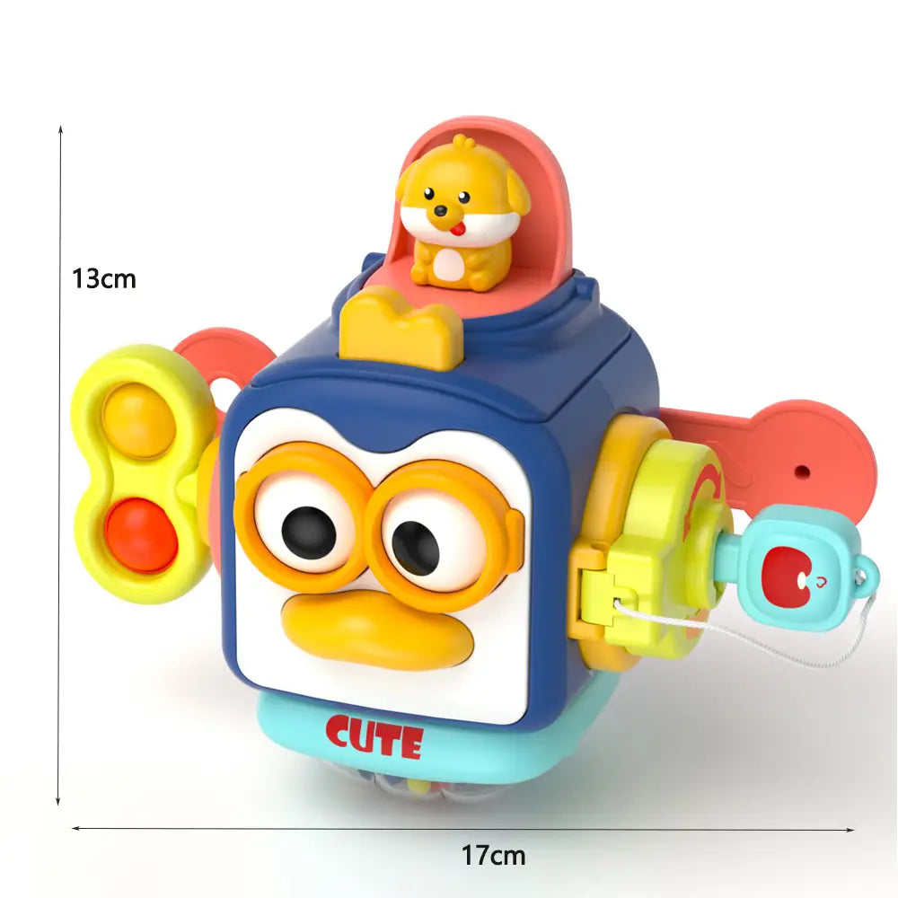 Jouet de voyage cube d’occupation Montessori : robot cartoon bleu et jaune au visage souriant, avec des boutons interactifs colorés sur les côtés, et une petite figurine de chiot jaune assise en haut.