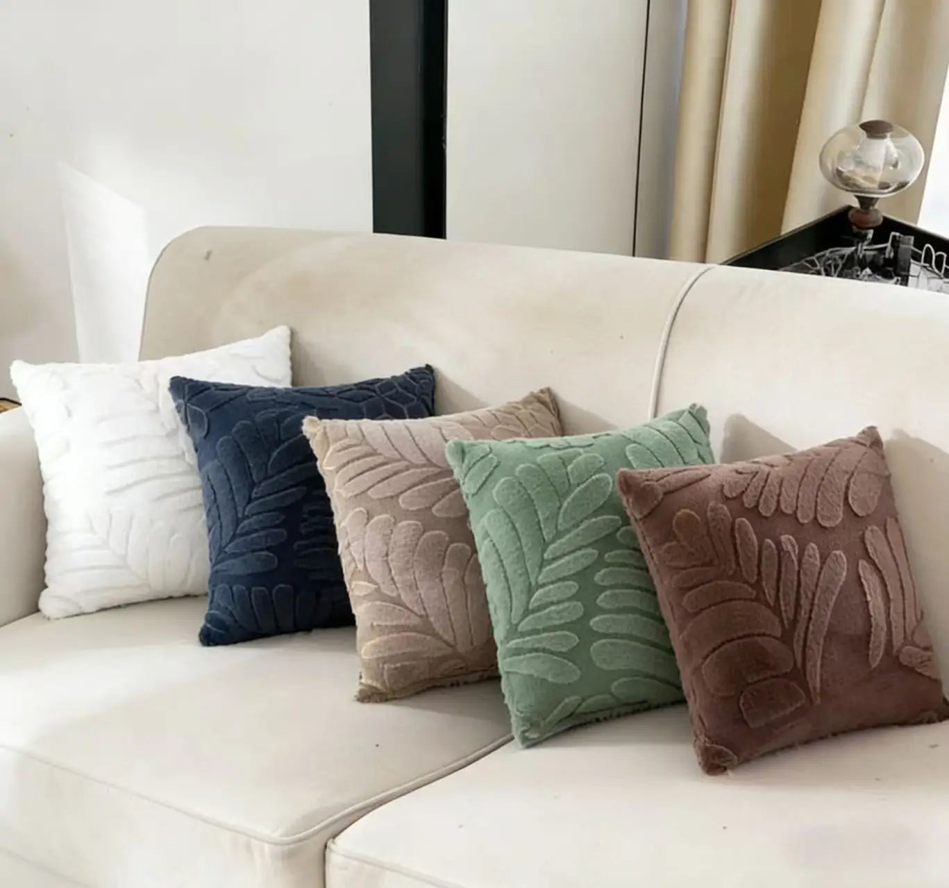 Set of five square velvet throw pillow covers in white navy blue beige sage green and brown featuring a raised leaf pattern for plush leaf embroidered throw pillow covers.