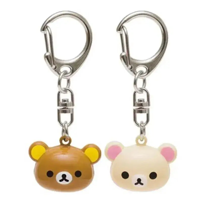 two rilakkuma bear keychain set cute enamel charms featuring one brown keychain with yellow ears and one cream-colored keychain with pink ears