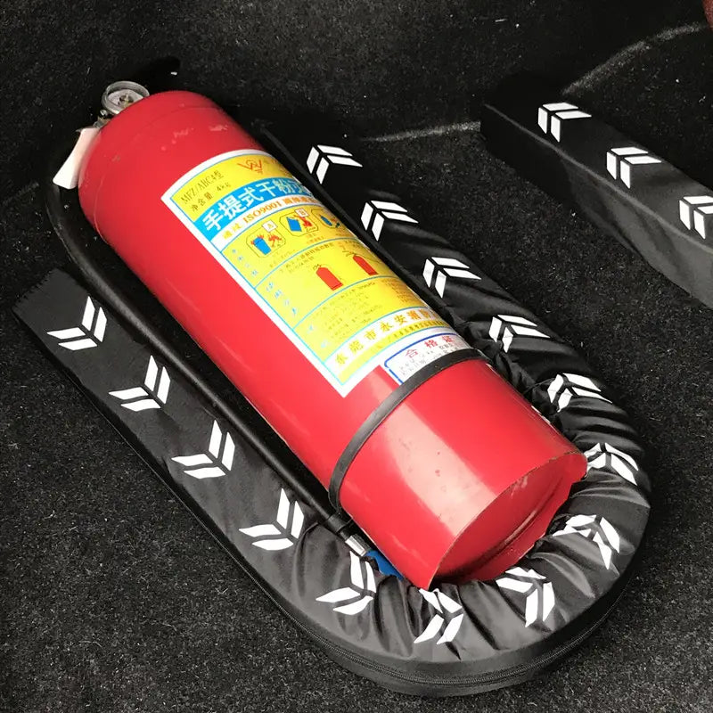Red cylindrical car-mounted fire extinguisher with a yellow label and black protective cushion featured in a car trunk organizer flexible anti-collision stick.