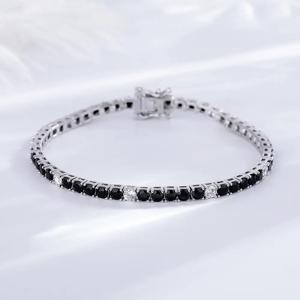 A sleek sterling silver black cz tennis bracelet 3mm adorned with black onyx and clear sparkling diamonds.