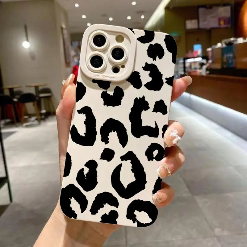 A sleek white leopard camera protective iPhone case with bold black leopard print pattern matte black finish and precise cutouts shown from the back side.