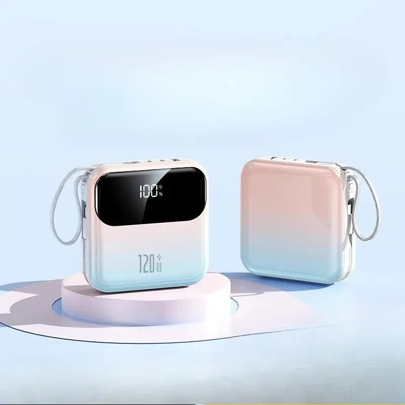 Pastel pink and light blue gradient power bank with 20000mah capacity and 120w fast charging featuring a digital display showing 100 percent battery level.