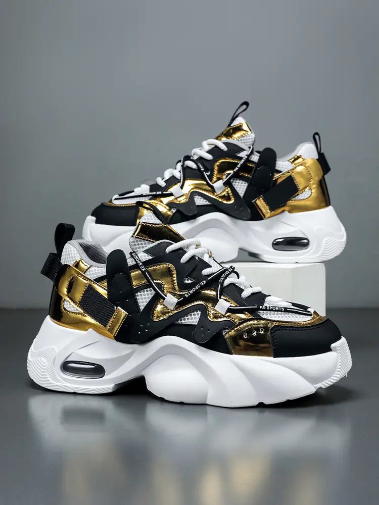 Men chunky air cushion casual sneakers in black and gold with white soles and visible air cushioning units.