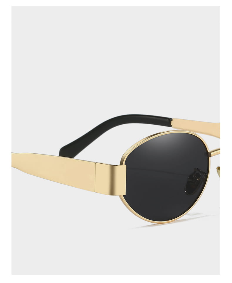 Gafas de sol ovaladas para mujer y hombre con montura en tono dorado y lentes negras, en un diseño moderno y elegante.