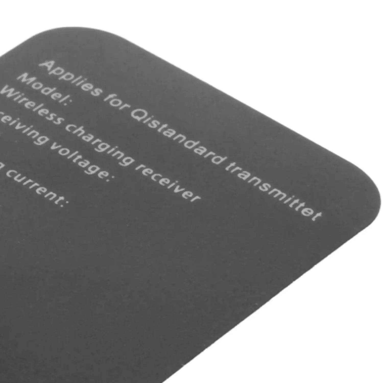 Black rectangular label with rounded corners on the back side of a wireless charging receiver type-c 10w fast charger featuring white text indicating applies for qi standard transmitter and other specifications.