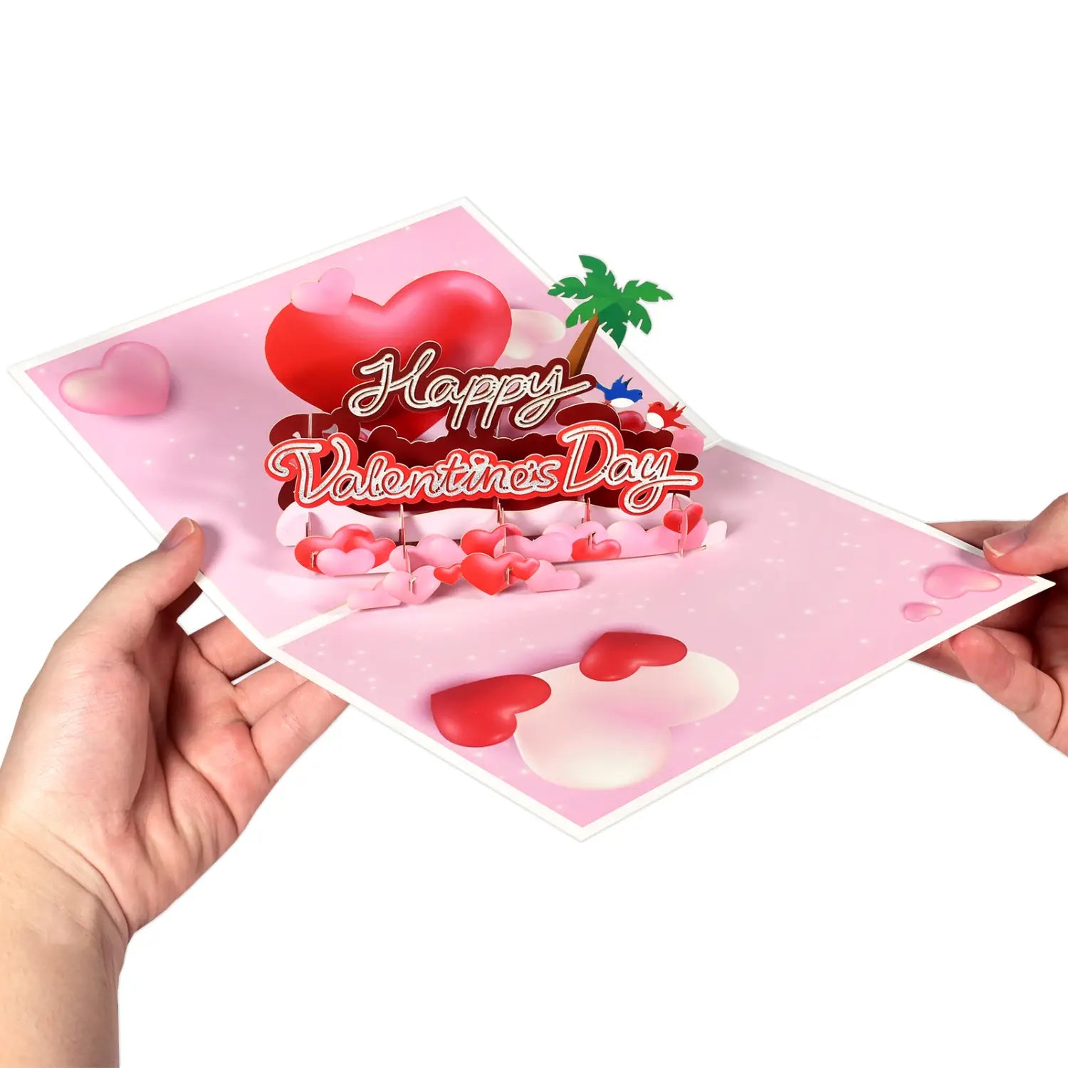 Carte de la Saint-Valentin 3D à effet pop-up rose, présentant un cœur rouge, un palmier et des cœurs épars, avec « Happy Valentine’s Day » en écriture cursive pour une salutation romantique en couple.