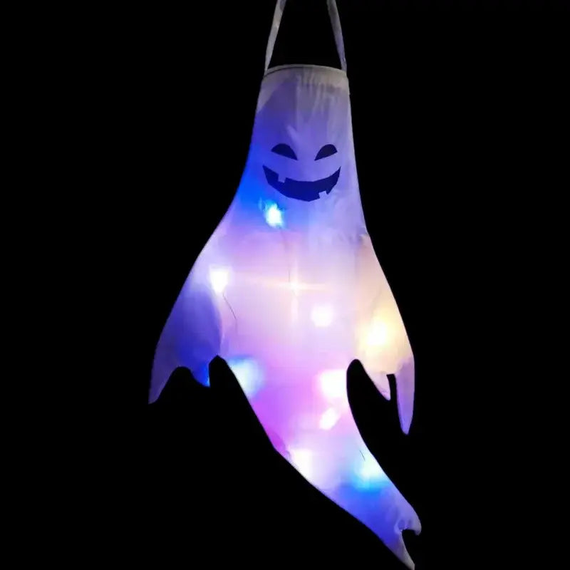 A glowing translucent ghost-shaped lantern with a smiling face and colorful LED lights designed as a Halloween ghost led hanging windsock for home outdoor use.