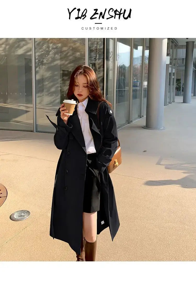 Black women double-breasted trench coat with classic design and subtle cuff detailing for casual windbreaker use.