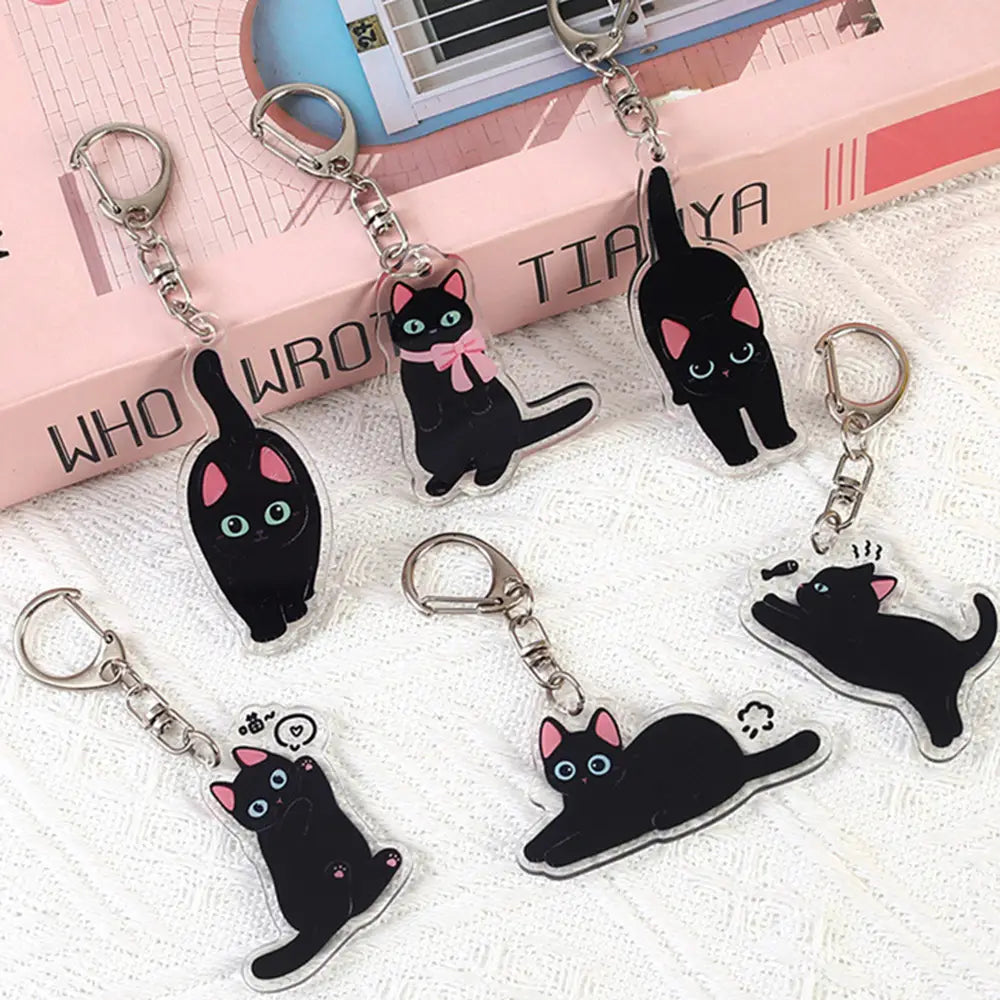 clear acrylic black cat keychains with pink inner ears blue eyes and some with pink bows designed as cartoon animal bag charms