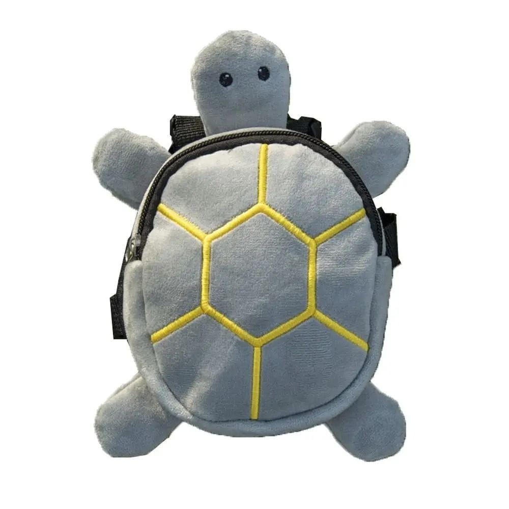 a soft gray plush turtle shape dog backpack with yellow stitched hexagonal patterns on its shell and black straps designed as a pet carrier