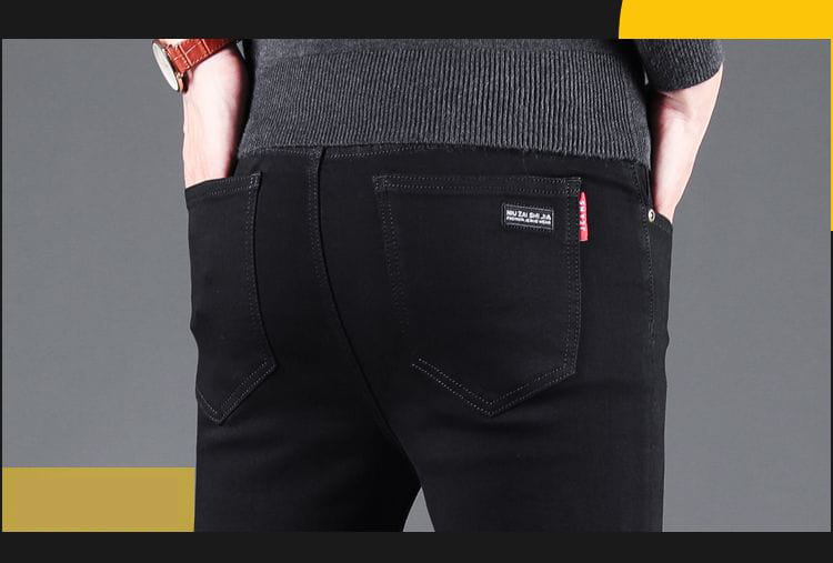 men black slim fit stretch denim jeans shown from the back side with subtle texture and reinforced stitching on the back pockets