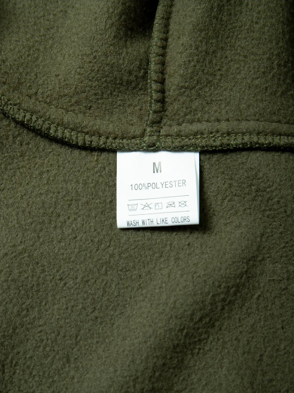 chaqueta polar táctica verde oliva para hombre, con abrigo con capucha de cremallera completa, confeccionada con 100% poliéster, con una etiqueta de cuidado blanca visible.