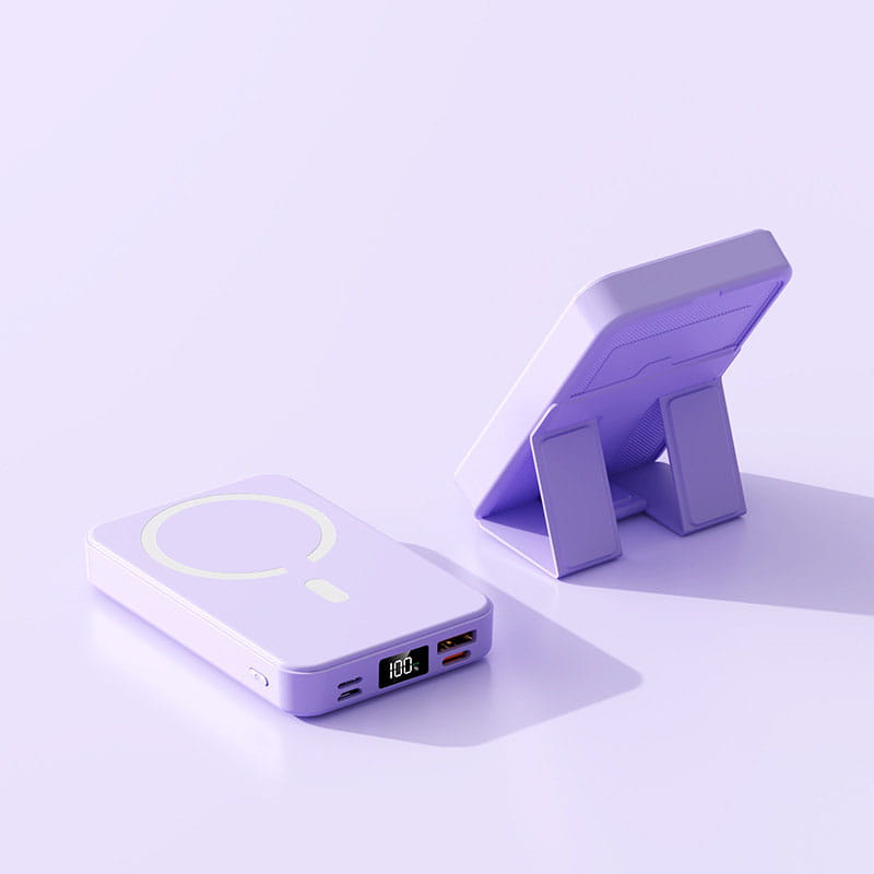 Lavender-colored magnetic power bank with built-in phone stand and digital display showing 100 percent battery level offering fast charging support.