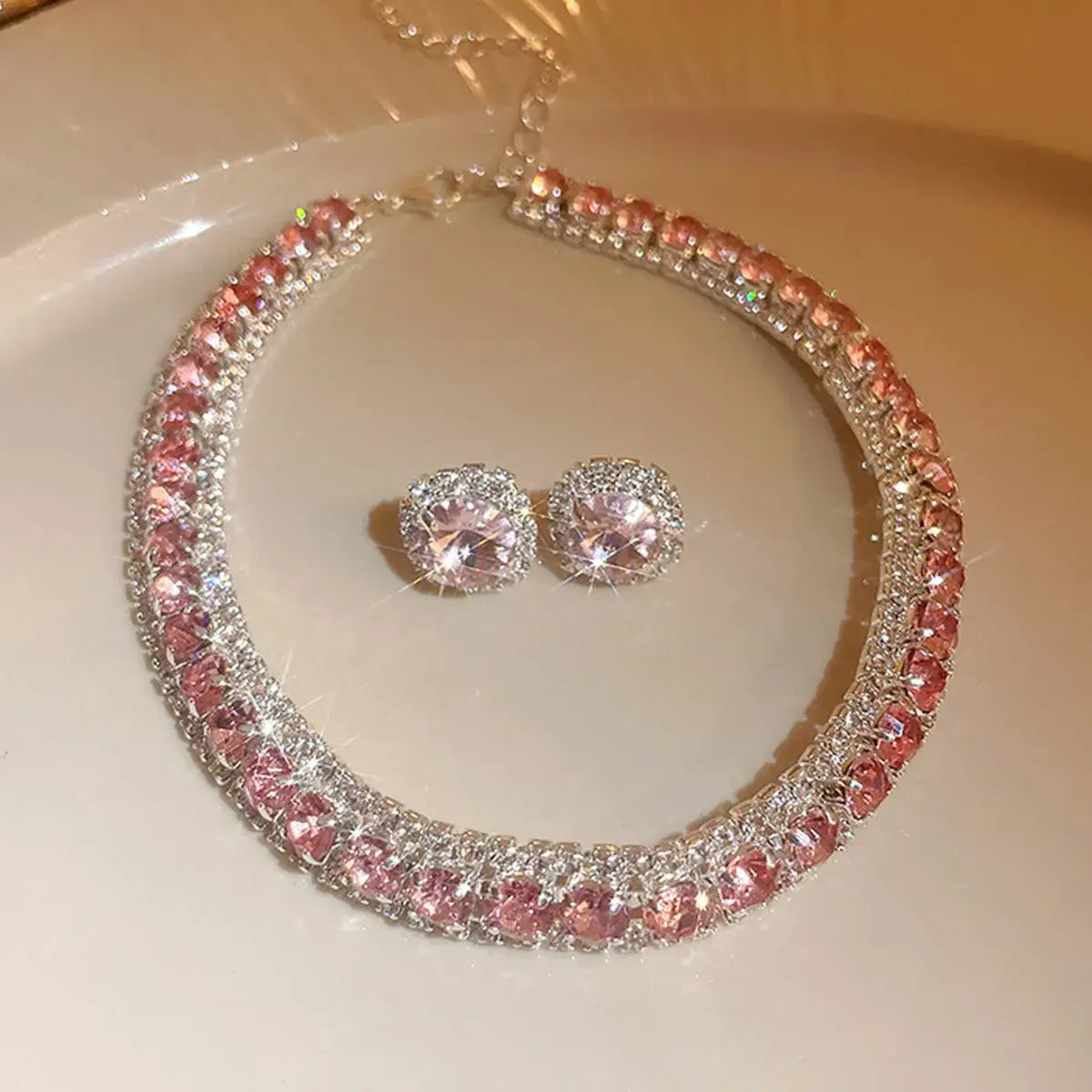 A sparkling pink and silver rhinestone choker necklace with matching stud earrings from the Crystal Necklace and Earring Set pink ab wedding jewelry collection.