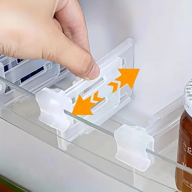 Adjustable refrigerator space divider made of clear white plastic with adjustable clips for organizing shelves.