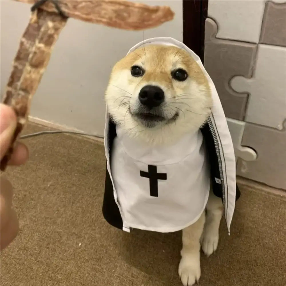 Un shiba inu esponjoso que lleva un disfraz de monja para perro-gato mascota con capucha, blanco y negro, hecho de fibra de poliéster, con un emblema de cruz en la parte frontal.