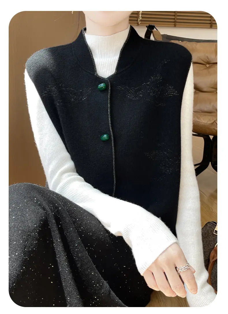 Black wool embroidered vest for women featuring subtle shimmering embroidery and emerald green buttons.