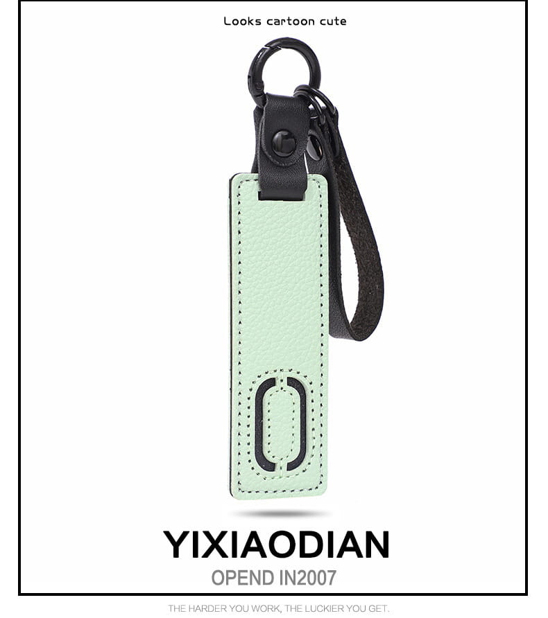 A mint green leather letter keychain with a black metal ring and strap featuring a stitched rectangular tag with an embossed circular logo ideal as an alphabet pendant party gift.