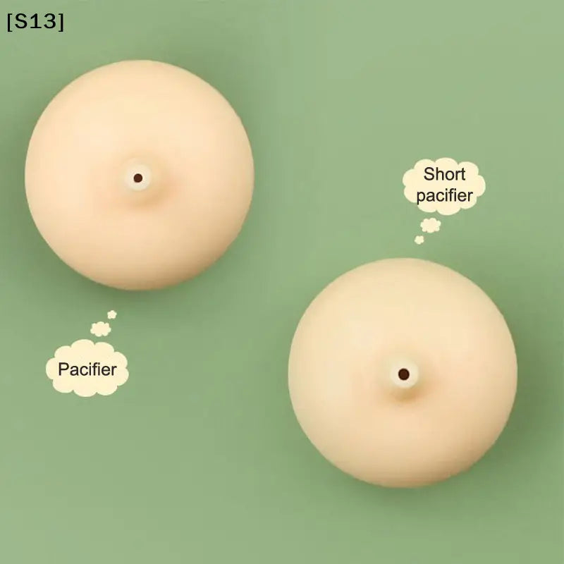 beige silicone pacifiers with central nipple hole and rounded smooth surfaces designed for a cat bottle feeder with measuring scale for newborn pets featuring a unique design.