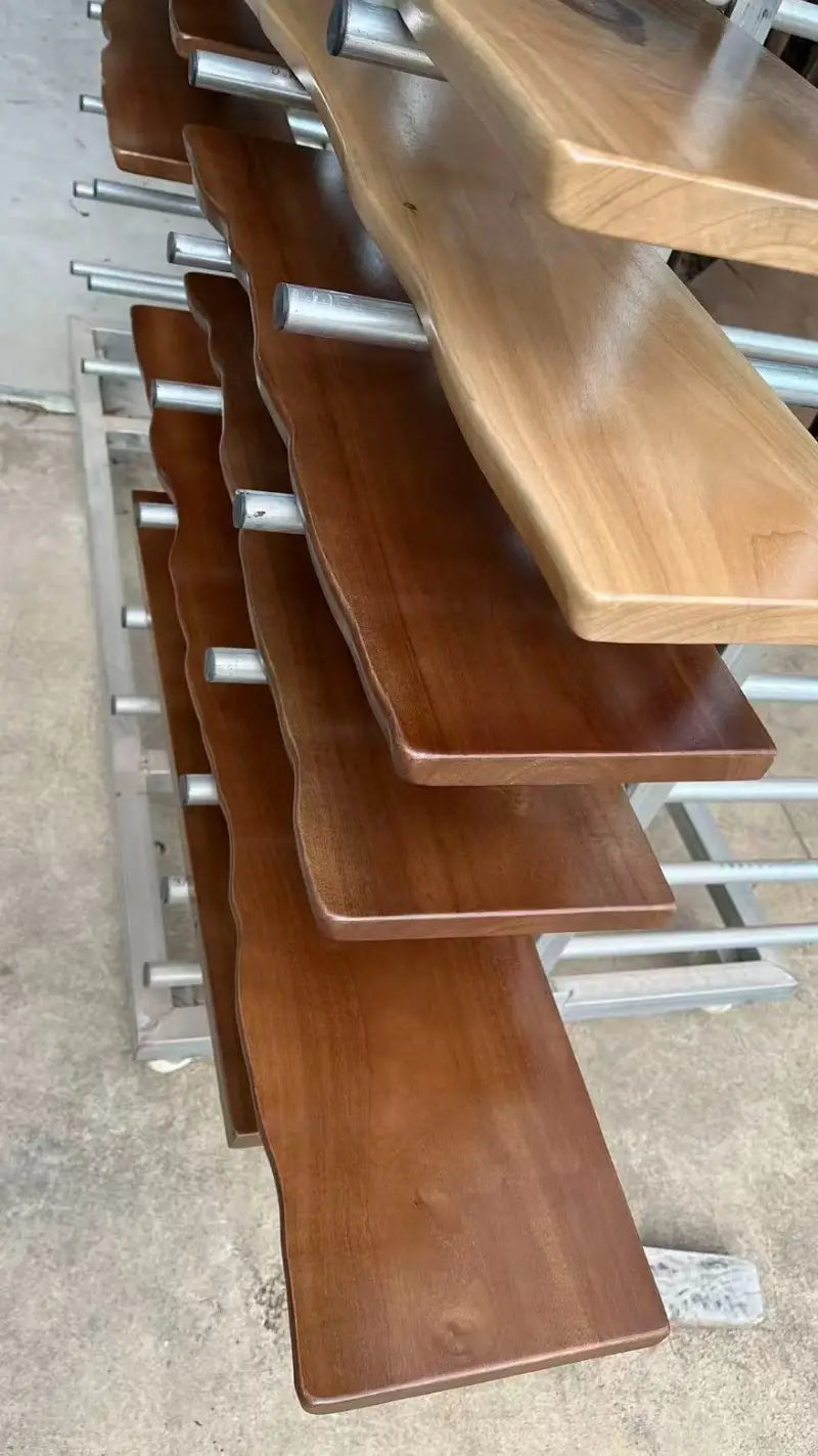 Stair-step wooden shelves with a natural wood finish and smooth slightly curved edges in a farmhouse wooden shelves live edge wall shelf.