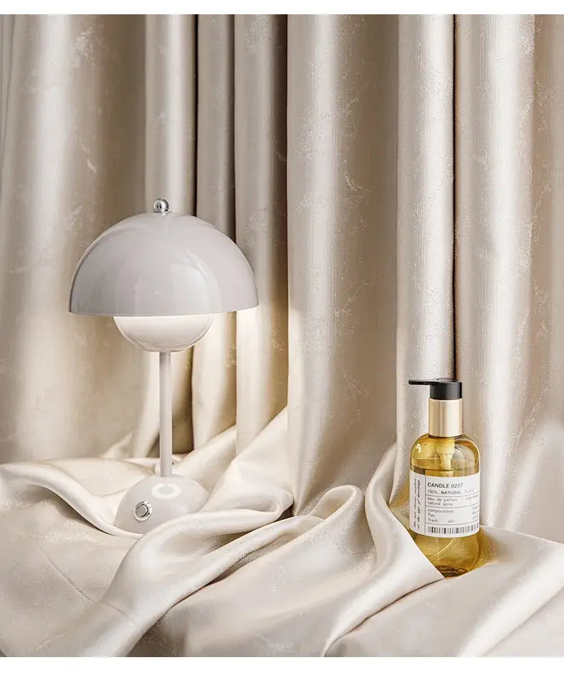 a sleek minimalist white table lamp with a smooth dome-shaped shade and slender stem complements living room custom blackout drapes para la sala with tassel tieback beads